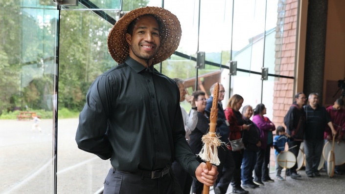 Man smiling at camera wearing traditional hat