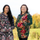 Two women in kuspuks outside in the fall