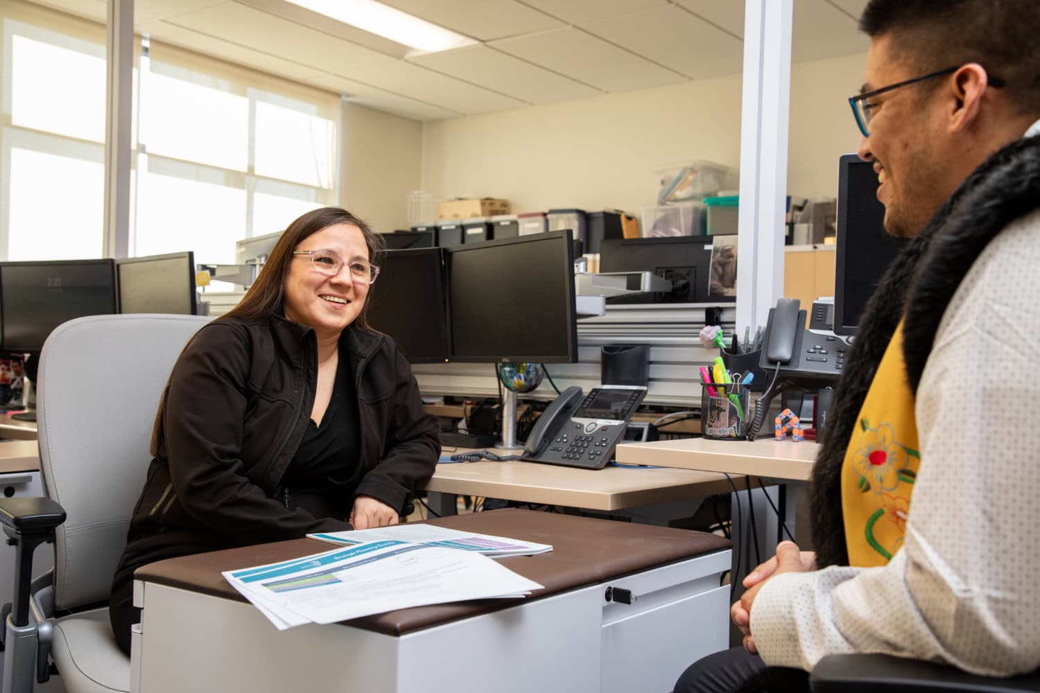 2026-03-30 HR Office Stock Photos010 Two people having a conversation in an office setting