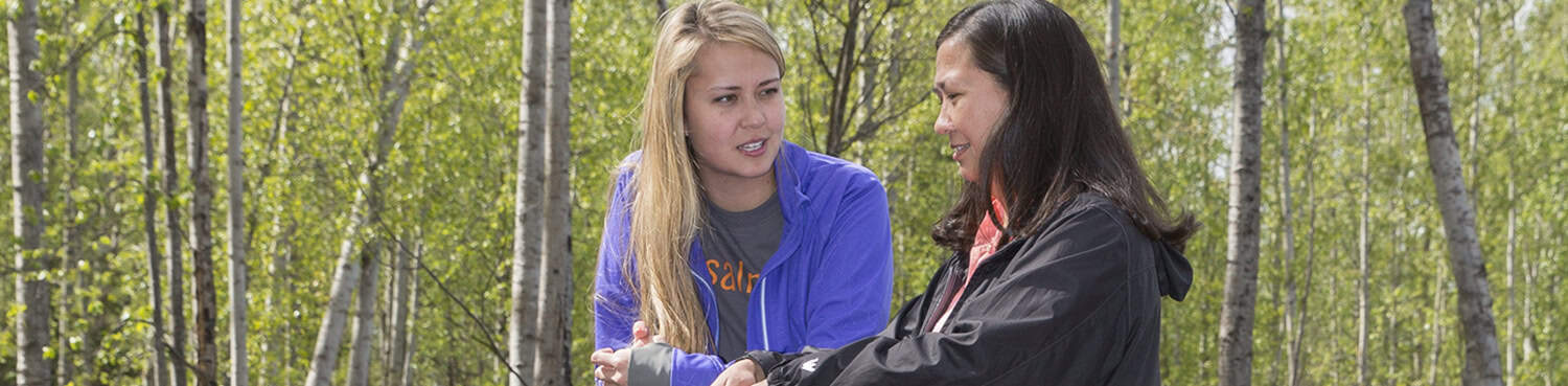 Two women talking outside